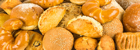 Croissants and Warious sweet pastries background. Wide photo.の写真素材