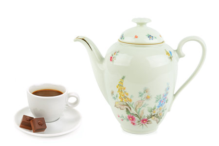 Elegant vintage porcelain coffee pot and a cup of coffee isolated on white background.の写真素材
