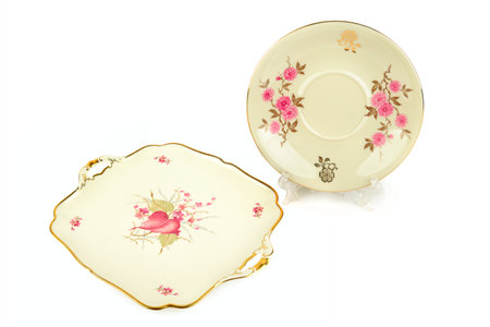 Vintage porcelain plates with elegant pattern isolated on white background. Collage. Free space for text.の写真素材