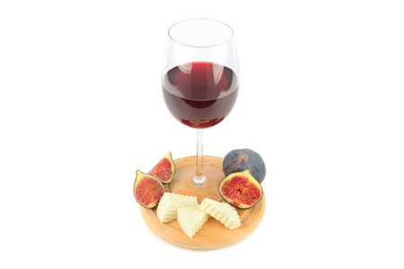 Glass of wine, cheese and fig fruit isolated on white background.の写真素材
