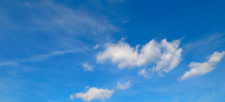 Fantastic soft white clouds against blue sky. Wide photo.の写真素材