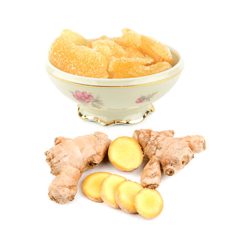 Candied ginger in a porcelain bowl and ginger root isolated on white background. Collage.の写真素材