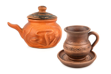 Small clay pot pot with lid and clay mug with saucer isolated on white background. Collage.の写真素材