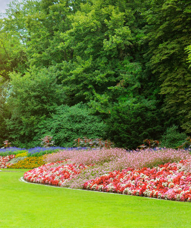 Summer garden with beautiful flowerbeds. Vertical photo.の写真素材