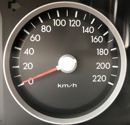 gray car speedometer with white numbers