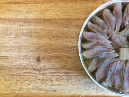 herring pieces in a jar on a light backgroundの写真素材