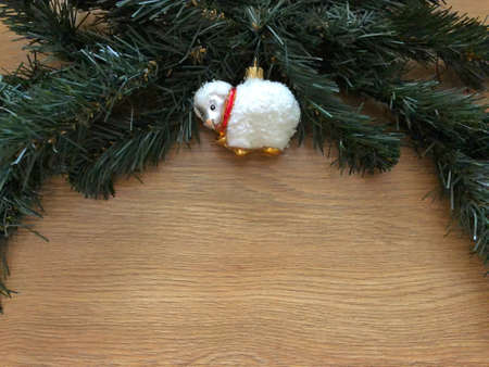 spruce branch with a toy on a wooden backgroundの写真素材