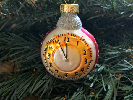 spruce branch with a toy on a wooden background
