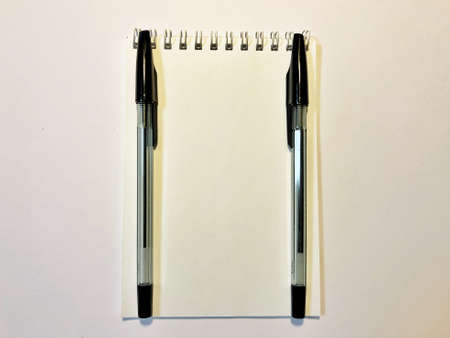 open notebook with blank pages and pen on white wooden deskの写真素材