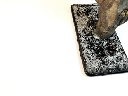 Broken glass mobile phone on a white background. Hammer beating on the phone