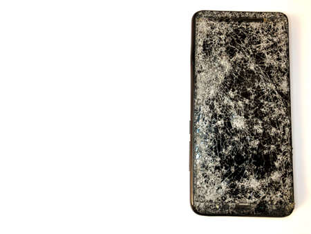 Broken glass mobile phone on a white backgroundの写真素材
