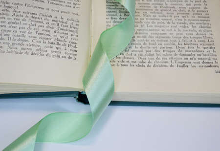 light green ribbon bookmark in a bookの写真素材