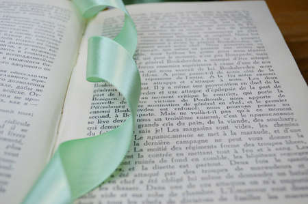 light green ribbon bookmark in a bookの写真素材