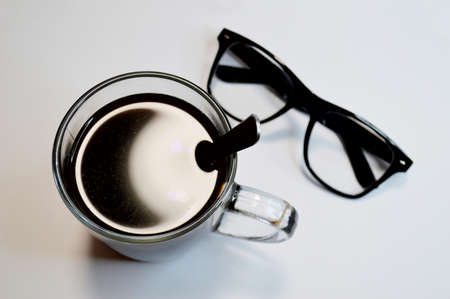 glasses and coffee on a white backgroundの写真素材