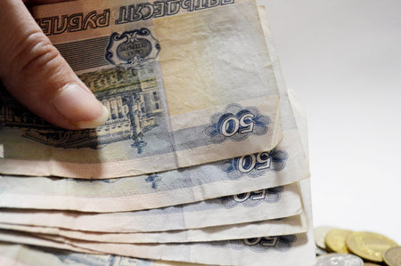 various banknotes and coin with symbol of russian ruble on the coins background