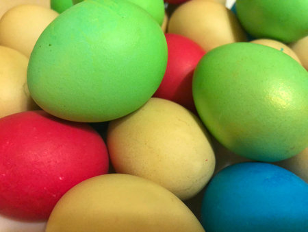 Easter background of colorful painted eggs close up
