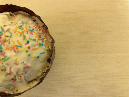 Easter sweet bread, paska on light wooden background. Orthodox kulich. Holidays breakfast concept...