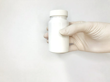 white glove with a white jar on a white background
