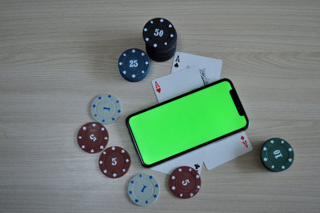 Poker background - chips, cards and phone with a green screen