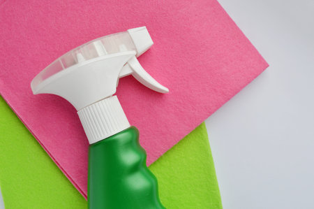 Cleaning rag in various colors and detergent on white background. Towels day