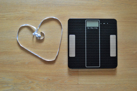 Lose weight concept with person on a scale measuring kilograms.