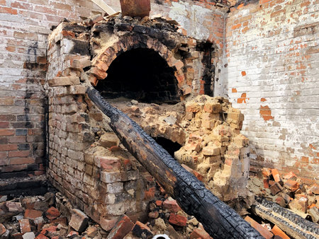 Burned house after fire, ruined building room inside, disaster or war aftermath conceptの写真素材