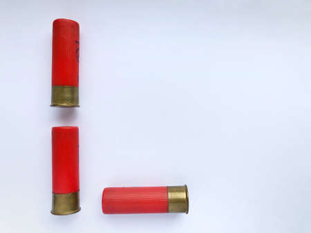 Several hunting cartridges and scattered pellets of cartridges isolated on a white background.の写真素材