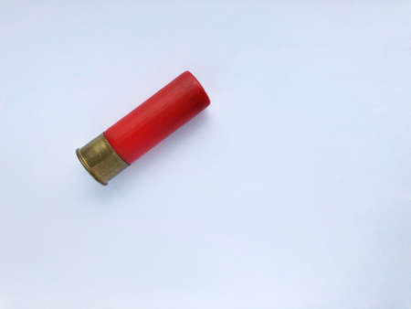 one shotgun cartridge on a white backgroundの写真素材