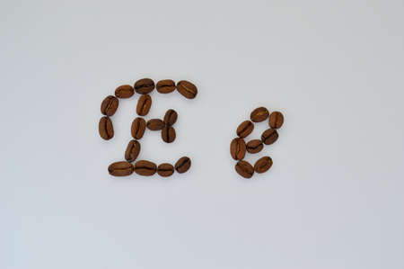 Uppercase letters e made of coffee beans on the white background.の写真素材