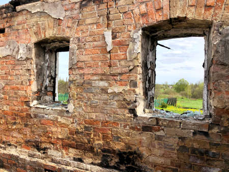 Burned house after fire, ruined building room inside, disaster or war aftermath conceptの写真素材