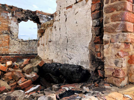 Burned house after fire, ruined building room inside, disaster or war aftermath conceptの写真素材