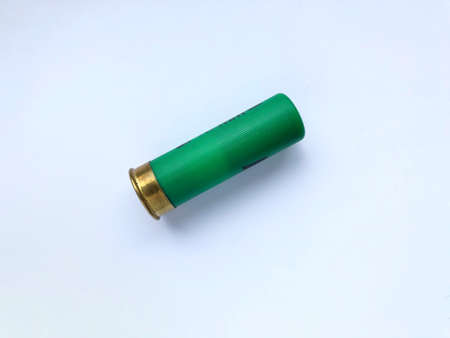 one shotgun cartridge on a white backgroundの写真素材