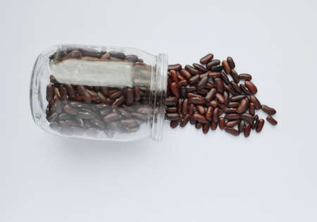 Red beans in glass jar isolated on white backgroundの写真素材