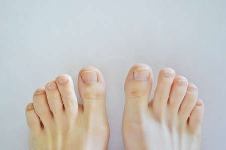 Closeup toenails isolated on a white background. Spa at homeの写真素材