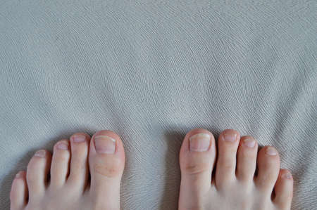 Closeup toenails isolated on a white background. Spa at homeの写真素材