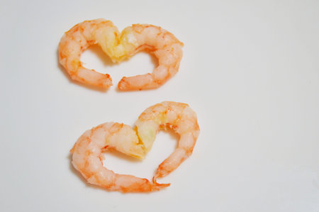 Shrimps laid out in a heart shape on a white background