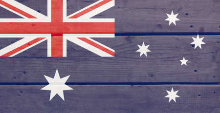 Australia flag painted on wood plank background. Brushed natural light knotted wooden board texture. Wooden texture background flag of Australia.の写真素材
