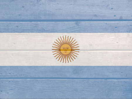 Argentina flag painted on wood plank background. Brushed natural light knotted wooden board texture. Wooden texture background flag of Argentinaの写真素材