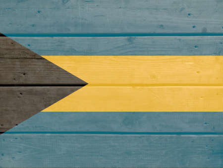 Bahamas flag painted on wood plank background. Brushed natural light knotted wooden board texture. Wooden texture background flag of Bahamasの写真素材