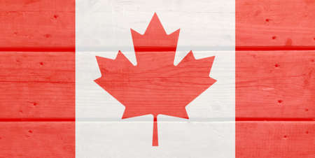 Canada flag painted on wood plank background. Brushed natural light knotted wooden board texture. Wooden texture background flag of Canada.の写真素材