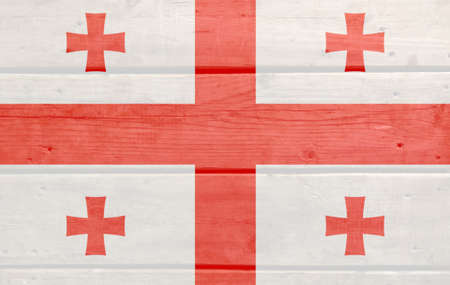 Georgia flag painted on wood plank background. Brushed natural light knotted wooden board texture. Wooden texture background flag of Georgiaの写真素材