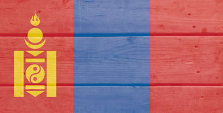 Mongolia flag painted on wood plank background. Brushed natural light knotted wooden board texture. Wooden texture background flag of Mongoliaの写真素材