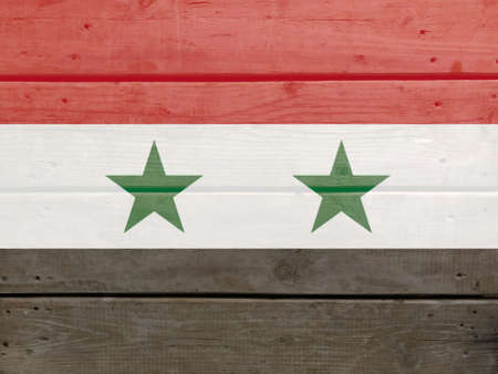 Syrian flag painted on wood plank background. Brushed natural light knotted wooden board texture. Wooden texture background flag of Syrianの写真素材
