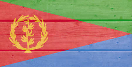 Eritrea flag painted on wood plank background. Brushed natural light knotted wooden board texture. Wooden texture background flag of Eritreaの写真素材