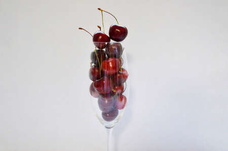 Cherry in a glass goblet on a white background.の写真素材