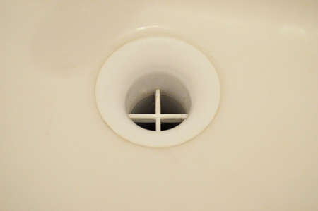 Water fallen in sink. Drain in a sink close.の写真素材