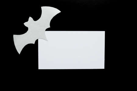 White paper bat lies on a black background with a white mockupの写真素材