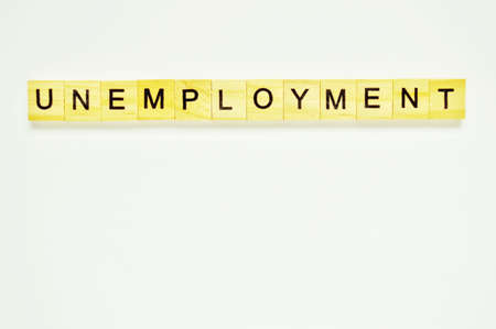 Word unemployment. Wooden blocks with lettering on top of white background. Top view of wooden blocks with letters on white surfaceの写真素材