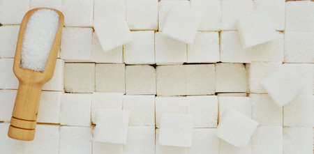 Refined sugar and a wooden spoon with a copy spaceの写真素材