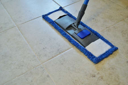 closeup of cleaning the ceramic floor with a mopの写真素材